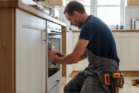 Installation team fitting a cabinet